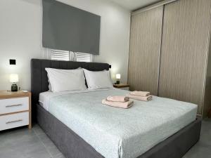 a bedroom with a bed with towels on it at Kilada Luxury Apartment 2 in Koilás