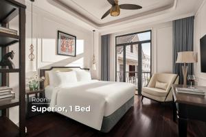 a bedroom with a bed and a desk and a chair at NIA Hotel in Da Lat