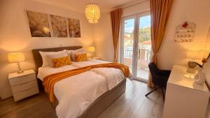 a bedroom with a bed and a large window at Apartment Lučka II in Banjol