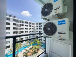 a room with a view of a building at Stylish Pool View 1BDR Apartment Bang Tao in Ban Thalat Choeng Thale