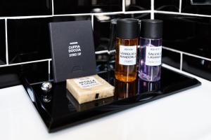 two bottles of essential oils and a box on a counter at I Sleep B&B in Florence +37 photos
