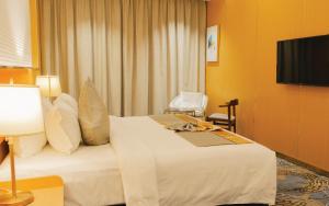 a hotel room with a bed and a television at Wisney Hotel in Sihanoukville