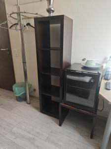 a black cabinet with a plate on top of it at Hotel am Markt Eschweiler in Eschweiler