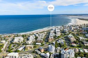 an aerial view of a beach with a sign that reads kick at Salt & Sky - Stylish Apartment with Pool & Spa in Caloundra