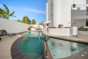 a swimming pool in the middle of a house at Salt & Sky - Stylish Apartment with Pool & Spa in Caloundra +33 photos