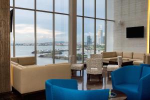 a living room with a view of the water at Hilton Panama in Panama City