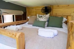 a bedroom with a large bed with pillows on it at 133onFifth in Umtali +33 photos