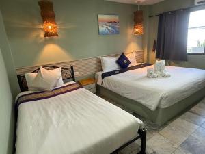 a bedroom with two beds with stuffed animals on them at Istanbul Boutique Hotel in Patong Beach