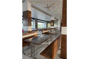 a row of tables in a large room at The Shivanta Inn in Ābu Road