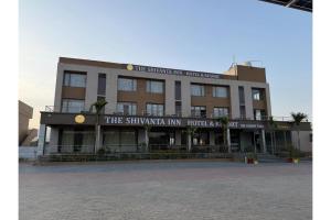 a building with a sign on the front of it at The Shivanta Inn in Ābu Road