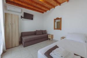 a bedroom with a bed and a couch at Pavlos Place in Antiparos +157 photos