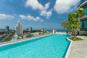 a swimming pool on the roof of a building at Hampton Sriracha in Si Racha