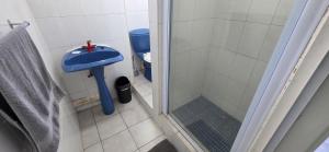 a bathroom with a shower and a blue sink at Seabrook 404 - Sleeps 8 in Margate +13 photos