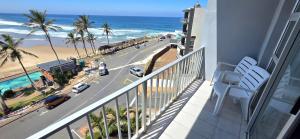 a balcony with a view of the beach and the ocean at Seabrook 404 - Sleeps 8 in Margate