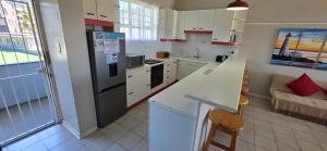 a kitchen with a refrigerator and a counter top at Seabrook 404 - Sleeps 8 in Margate