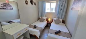 a small room with two beds and a window at Seabrook 404 - Sleeps 8 in Margate