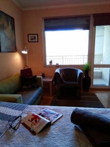 a living room with a couch and a chair at Apartment 132 in Sofia