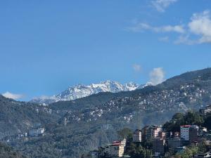 a view of a city with snow capped mountains at Bagaicha Farms in Tādong