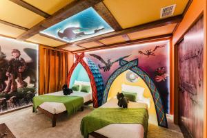two beds in a room with a mural at Spacious 9BR Home w Private PoolGame Room in Davenport +63 photos