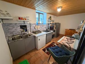 a kitchen with a sink and a counter top at L' Èef Cascina in San Cassiano