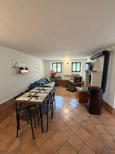 a living room with a table and chairs and a living room at L' Èef Cascina in San Cassiano