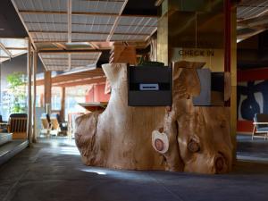 a large wooden sculpture of a cow in a room at HOTEL FORK & KNIFE Miyajima in Miyajima