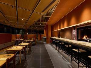 a dining room with wooden tables and chairs at HOTEL FORK & KNIFE Miyajima in Miyajima