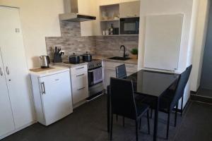 a kitchen with a table and a stove top oven at Ferienwohnung NR2 in Großräschen