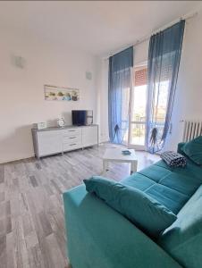 a living room with a couch and a table at Sweet home in Novara