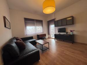 a living room with a couch and a table at Apartamentos Rondaluz in Ronda