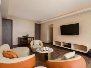a living room with a flat screen tv at The Zen in Jiufen +40 photos