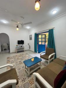 a living room with a couch and a table at AV apartment beach candolim in Aguada