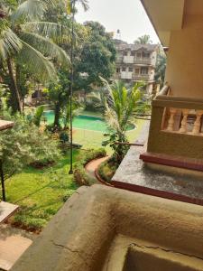 a view of a swimming pool from a balcony of a house at AV apartment beach candolim in Aguada