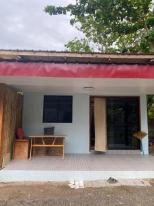 a small house with a red roof at Entire home in General Luna in General Luna
