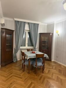 a dining room with a table and chairs and a window at Casa Malù in Torre Annunziata