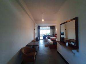 a living room with a mirror and a couch at Green Villa Ella in Ella +87 photos