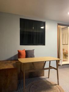a living room with a wooden table and a window at Entire home in General Luna in General Luna