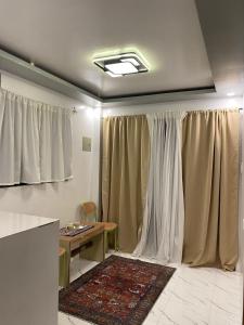 a living room with curtains and a table and a table at Entire home in General Luna in General Luna