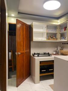 a kitchen with a stove and an open door at Entire home in General Luna in General Luna