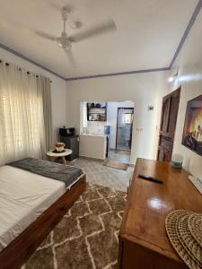 a bedroom with a bed and a desk in it at nova nest in Watamu