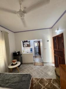 a room with a bed and a table and a kitchen at nova nest in Watamu