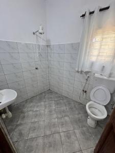 a bathroom with a toilet and a sink at nova nest in Watamu