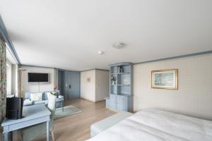 a bedroom with a bed and a living room at Hotel Säntis - Genuss & Tradition in Appenzell