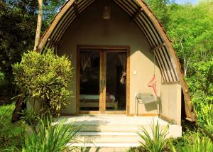 a small house with a glass door and stairs to it at Pedidi Penida Hostel in Nusa Penida