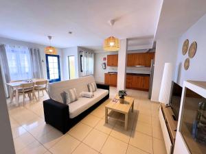 a living room with a couch and a table at Evita Beach Suites Exclusivas in Caleta de Sebo