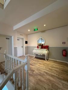 a room with a staircase with a table and a mirror at Hotel Lungomare in Vlorë +39 photos