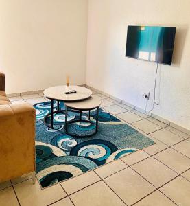 a room with a table and a rug on the floor at Alldays Sunset Lodge Wilde Street in Alldays