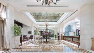 a lobby with a chandelier and a fountain at Angel's Marmaris Hotel in Turgut +125 photos