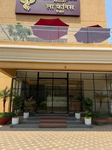 a building with plants sitting outside of it at La Fenice Resort Madh Island in Mumbai