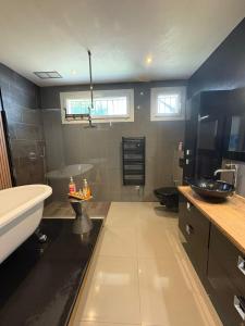 a large bathroom with a tub and a sink at Appartement jardin in Le Cannet +61 photos